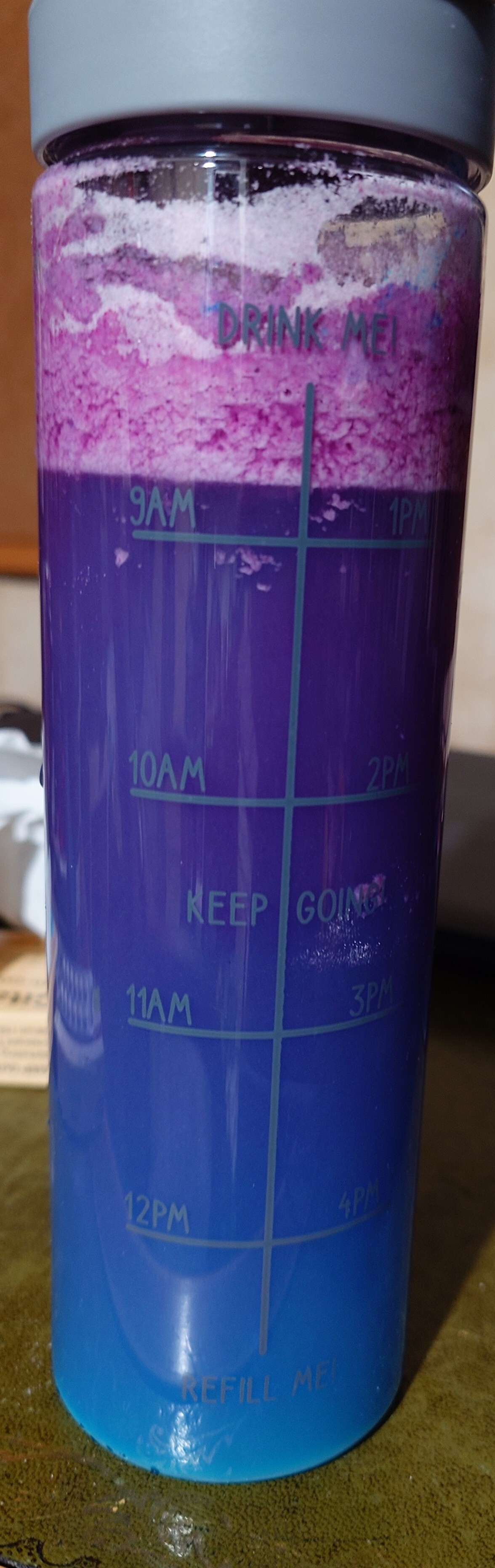 a container with a liquid showing the bi flag colours 