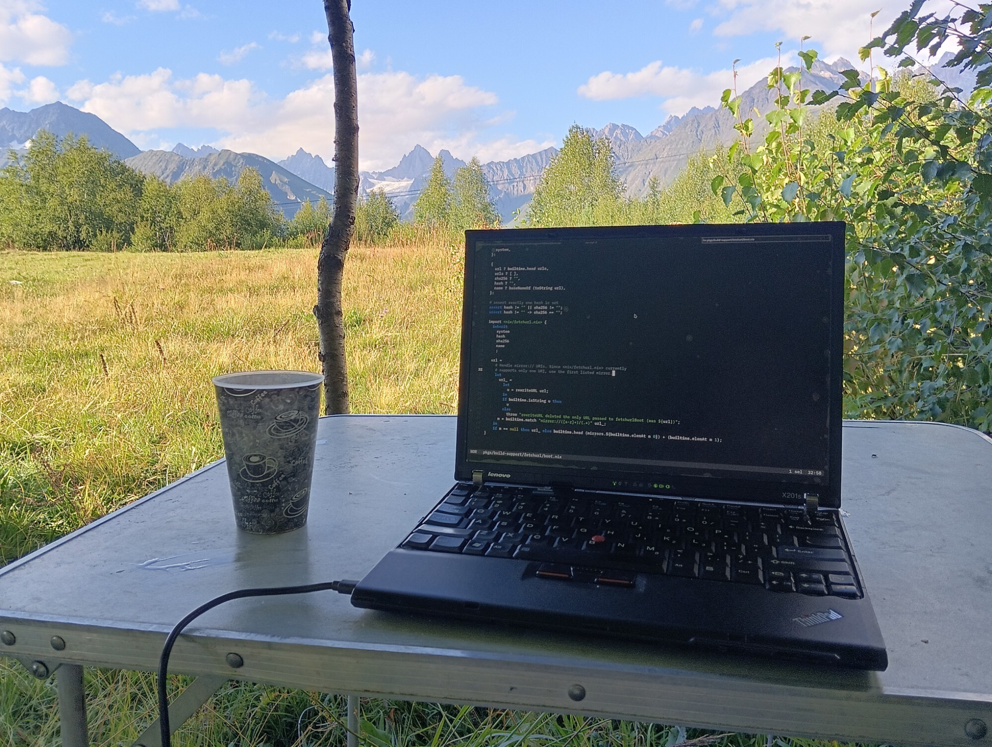 ThinkPad X201s with mountains in the background